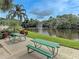 Community picnic area with tables overlooking a serene lake and water fountain at 279 Park Forest Blvd, Englewood, FL 34223