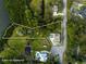 Aerial view of an estate with a large lot, swimming pool, and lake access at 310 79Th Nw St, Bradenton, FL 34209