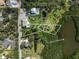 Expansive property featuring a meticulously kept lawn, a private pool, and waterfront access at 310 79Th Nw St, Bradenton, FL 34209