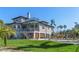 Back of home with a spacious deck overlooking a private pool and lush landscaping at 310 79Th Nw St, Bradenton, FL 34209