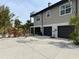 Exterior of a two-story home with a three-car garage and a private balcony, surrounded by landscaping at 310 79Th Nw St, Bradenton, FL 34209