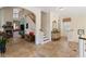 Open foyer with staircase, travertine floors, and a view into the living areas at 310 79Th Nw St, Bradenton, FL 34209