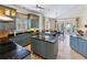 Stylish kitchen with custom blue cabinets, granite countertops, and stainless steel appliances at 310 79Th Nw St, Bradenton, FL 34209