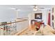 Loft with hardwood floors and railings overlooking living spaces below at 310 79Th Nw St, Bradenton, FL 34209