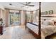 Elegant main bedroom suite featuring a four-poster bed, private balcony, and neutral decor at 310 79Th Nw St, Bradenton, FL 34209