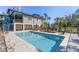 Backyard showcases a large pool, seating areas, and tropical landscaping at 310 79Th Nw St, Bradenton, FL 34209