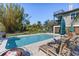 Beautiful backyard features a pool, lounge chairs, and a dining area at 310 79Th Nw St, Bradenton, FL 34209