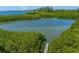 Scenic view of a peaceful waterway with mangrove trees and a wooden dock at 310 79Th Nw St, Bradenton, FL 34209