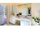 Bright bathroom featuring double vanity, a large mirror, and a door to the outside at 3116 Woodland Fern Dr, Parrish, FL 34219