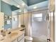 Well-lit bathroom with blue ceiling, a large mirror, and a tub with shower at 3116 Woodland Fern Dr, Parrish, FL 34219