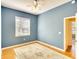 Cozy bedroom featuring hardwood floors, neutral rug, and a window offering plenty of natural light at 3116 Woodland Fern Dr, Parrish, FL 34219