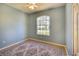 Bedroom featuring hardwood floors, neutral rug, and a beautiful arched window offering plenty of natural light at 3116 Woodland Fern Dr, Parrish, FL 34219