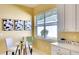 Cozy breakfast nook with a glass table, chairs, and view to the backyard at 3116 Woodland Fern Dr, Parrish, FL 34219
