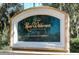 Elegant community sign for River Wilderness Golf & Country Club, a deed restricted community with beautiful landscaping at 3116 Woodland Fern Dr, Parrish, FL 34219