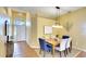 A dining area featuring a wooden table, seating for six, and view to the foyer provides a warm gathering space at 3116 Woodland Fern Dr, Parrish, FL 34219
