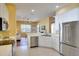Bright kitchen featuring stainless steel appliances, ample counter space, and a view into the living room at 3116 Woodland Fern Dr, Parrish, FL 34219