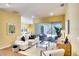 Inviting living room with a comfortable sofa, neutral color scheme, and views of the screened-in lanai and lush outdoors at 3116 Woodland Fern Dr, Parrish, FL 34219