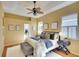 Comfortable main bedroom features a ceiling fan, ensuite bathroom, and ample natural light at 3116 Woodland Fern Dr, Parrish, FL 34219