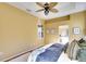 Comfortable main bedroom features a ceiling fan, ensuite bathroom, and ample natural light at 3116 Woodland Fern Dr, Parrish, FL 34219