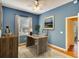 This home office features a rustic desk, neutral rug, and bright natural light from the window at 3116 Woodland Fern Dr, Parrish, FL 34219
