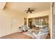 Relaxing covered patio with comfortable seating, ceiling fan, and views of the inviting pool area at 3116 Woodland Fern Dr, Parrish, FL 34219