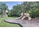 Community playground with multiple slides, and picnic table offers a fun, safe recreational space at 3116 Woodland Fern Dr, Parrish, FL 34219