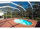 Inviting screened-in pool area with mature landscaping offering a private outdoor retreat at 3116 Woodland Fern Dr, Parrish, FL 34219