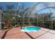Inviting screened-in pool area with mature landscaping offering a private outdoor retreat at 3116 Woodland Fern Dr, Parrish, FL 34219