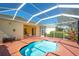 Backyard features an inviting kidney-shaped pool and an enclosed patio area, perfect for outdoor living at 3116 Woodland Fern Dr, Parrish, FL 34219