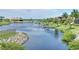 Waterfront view overlooking serene canal with private boat docks, lush landscaping and homes in background at 3116 Woodland Fern Dr, Parrish, FL 34219