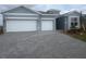 Attractive home exterior featuring a three-car garage and modern curb appeal at 3412 Night Star Terrace, Parrish, FL 34219