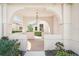 Inviting entryway with arched doorway and views of the landscaped front yard at 3829 Alamanda Dr, Sarasota, FL 34238