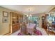 Formal dining room with a large wooden hutch, dining table set for six, and elegant chandelier at 4003 Bayside Dr, Bradenton, FL 34210