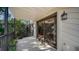 Covered patio featuring a sliding door and black metal railings, blending indoor-outdoor living at 4003 Bayside Dr, Bradenton, FL 34210