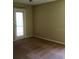 Neutral-toned bedroom featuring a door to the outside and neutral carpet at 4008 Crockers Lake Blvd # 11, Sarasota, FL 34238
