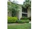 Exterior view of a two-story home featuring lush landscaping and a charming balcony at 4008 Crockers Lake Blvd # 11, Sarasota, FL 34238