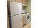 Kitchen with white appliances and light wood cabinets at 4008 Crockers Lake Blvd # 11, Sarasota, FL 34238