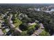 An aerial view of a community with houses surrounded by lush trees and greenery, including a pond at 4050 Oakhurst Dr # 3175, Sarasota, FL 34233