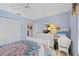 Fresh bedroom featuring white furnishings, adjacent computer desk, and light blue walls at 4050 Oakhurst Dr # 3175, Sarasota, FL 34233