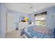 Light-filled bedroom with white furniture, colorful bedding, and a spacious closet at 4050 Oakhurst Dr # 3175, Sarasota, FL 34233