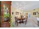 Cozy dining room with a round table, chandelier, and display cabinet with natural light at 4050 Oakhurst Dr # 3175, Sarasota, FL 34233