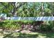 Oakhurst entrance sign surrounded by lush greenery, creating a welcoming and attractive entry to the neighborhood at 4050 Oakhurst Dr # 3175, Sarasota, FL 34233