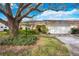 Charming single-story home with a well-manicured lawn, mature trees, and an attached two-car garage at 4050 Oakhurst Dr # 3175, Sarasota, FL 34233