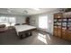 Bright game room with a billiard table, bookcase filled with puzzles, and a sitting area for relaxation and games at 4050 Oakhurst Dr # 3175, Sarasota, FL 34233