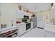 Bright kitchen features white cabinets, tile flooring, and stainless appliances at 4050 Oakhurst Dr # 3175, Sarasota, FL 34233