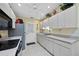Galley kitchen with white cabinets and modern appliances with great natural light at 4050 Oakhurst Dr # 3175, Sarasota, FL 34233