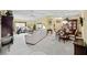 Open-concept living area with a large white sofa, neutral carpet, and seamless flow to the dining area at 4050 Oakhurst Dr # 3175, Sarasota, FL 34233