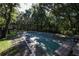 Outdoor shuffleboard court shaded by mature trees, offering a recreational space for residents at 4050 Oakhurst Dr # 3175, Sarasota, FL 34233