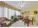 Sun Room is furnished with wicker furniture and tiled flooring with lots of natural light at 4050 Oakhurst Dr # 3175, Sarasota, FL 34233