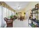 Sun Room is furnished with wicker furniture and tiled flooring with lots of greenery at 4050 Oakhurst Dr # 3175, Sarasota, FL 34233